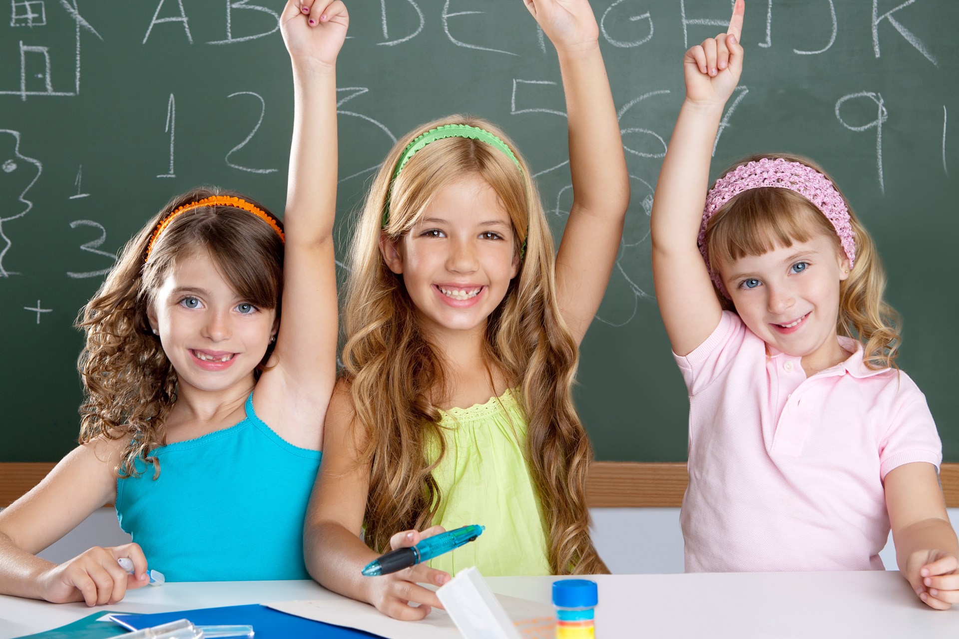 clever kids student group at school classroom raising hand as smart children